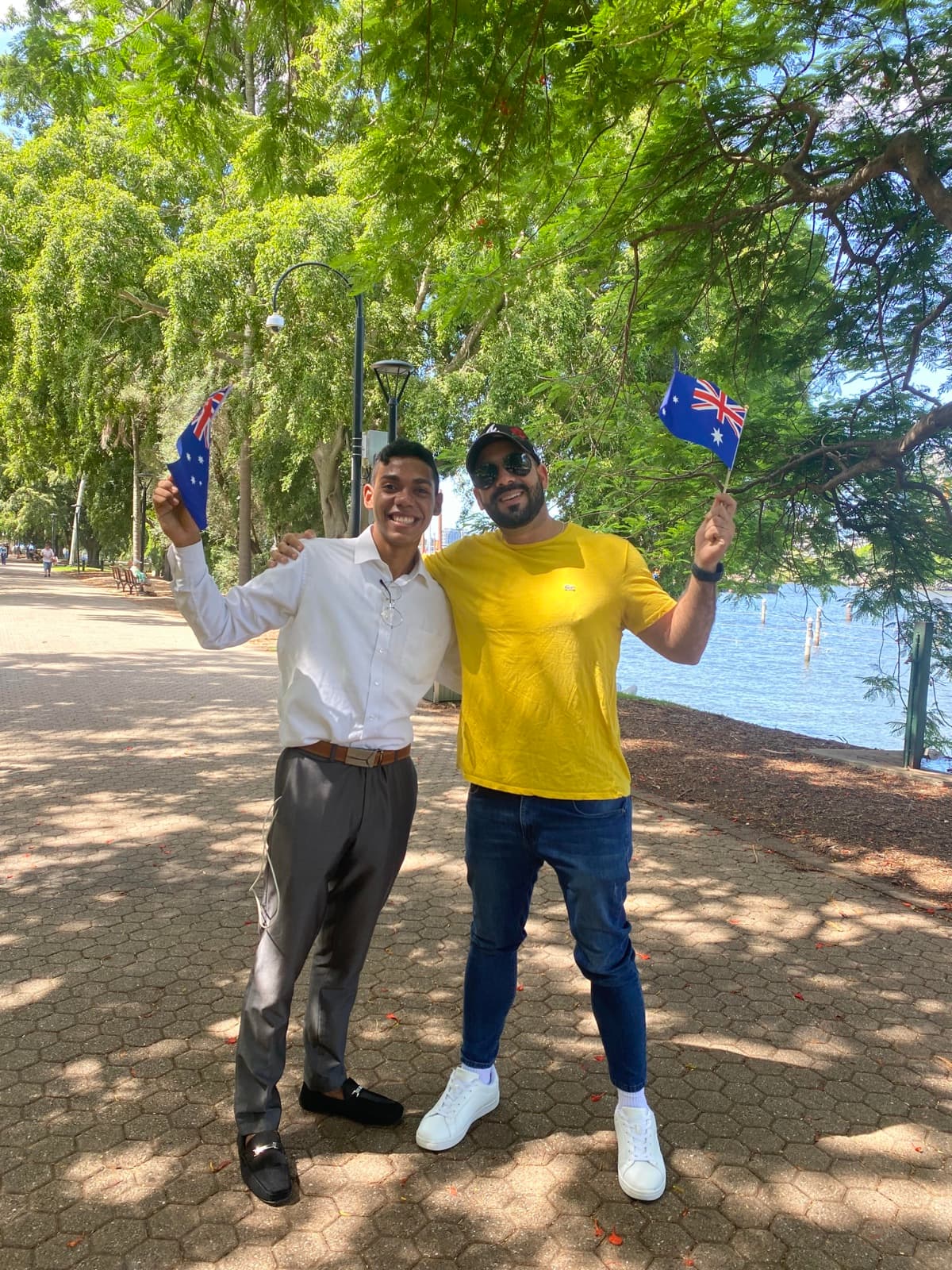 Dues persones amb banderes australianes al costat d’un llac