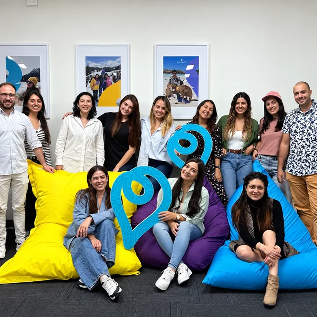 Nōmadas Experience team together in an office